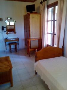 A bed or beds in a room at Pansion Matoula