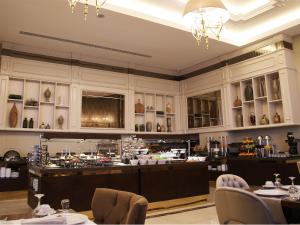 a restaurant with tables and chairs in a room at Morrian Hotel in Inegol