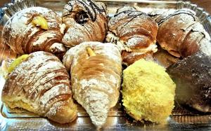 a tray of different types of pastries on a table at Cervara Park Hotel in Rome
