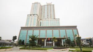 a large glass building with a large tall building at Muong Thanh Luxury Phu Tho in Việt Trì
