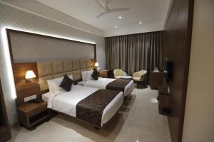 Posteľ alebo postele v izbe v ubytovaní Hotel Radiance