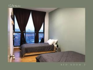 a bedroom with two beds and a large window at KL Gateway Mall - Easy Access to KL Sentral & KLCC in Kuala Lumpur +21 photos