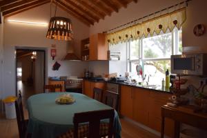 a kitchen with a table with a blue table cloth on it at Casa do Avô Cristiano in Madalena