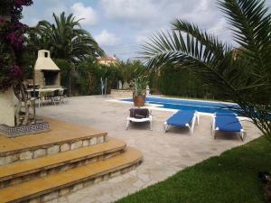 a patio with two chairs and a swimming pool at Meier's in L'Ametlla de Mar