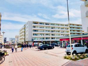 a large white building with people walking in front of it at Strand No.27 in Westerland