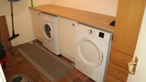 a washer and dryer in a room with a door at The Old Legion in Eyemouth
