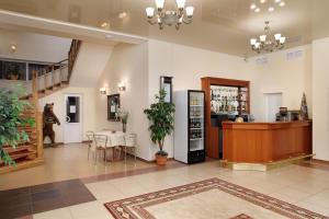 a lobby with a table and chairs and a pharmacy at Hotel Belalakaya in Dombay