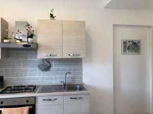 a kitchen with a sink and a stove top oven at CASALE PRATOTERRA 2 in Bracciano