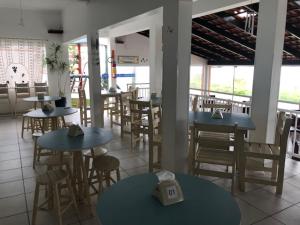 a restaurant with tables and chairs in a room at Recanto Da Val in São Francisco do Sul