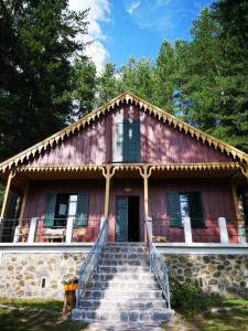 a house with stairs leading up to it at Baita Marilù in Lorica +18 photos