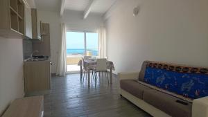 a living room with a couch and a table with a view at SGC Boa Vista Apartments in Sal Rei