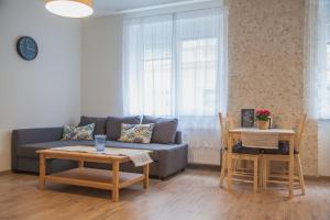 a living room with a couch and a table at Downtown pedestrian zone apartment in Bratislava