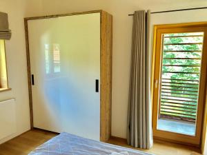 a bedroom with a white door and a window at Ferienwohnung Springer in Schliersee