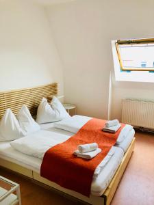 a bedroom with a large bed with towels on it at Aparthotel Bianca in Vienna