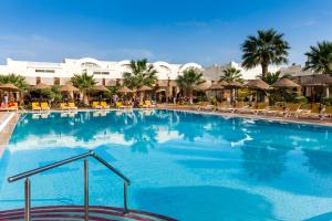 a large pool with chairs and umbrellas at a resort at TUI MAGIC LIFE Penelope Beach - Families & Couples in Midoun
