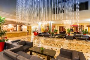 a hotel lobby with couches and a large chandelier at TUI MAGIC LIFE Penelope Beach - Families & Couples in Midoun