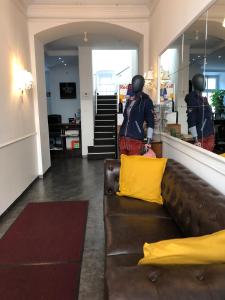 a couple of people standing in a store with a couch at Urban Stay Salzburg City in Salzburg