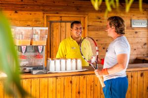 a man and a woman holding a tennis racket at TUI MAGIC LIFE Penelope Beach - Families & Couples in Midoun