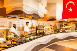 a group of chefs in a kitchen preparing food at TUI MAGIC LIFE Penelope Beach - Families & Couples in Midoun