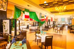 a restaurant with tables and chairs and a cafeteria at TUI MAGIC LIFE Penelope Beach - Families & Couples in Midoun
