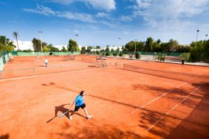a group of people playing tennis on a tennis court at TUI MAGIC LIFE Penelope Beach - Families & Couples in Midoun