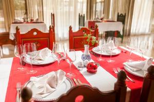 a table with wine glasses and a red table cloth at TUI MAGIC LIFE Penelope Beach - Families & Couples in Midoun
