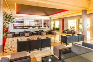 a lobby of a hotel with chairs and a bar at TUI MAGIC LIFE Penelope Beach - Families & Couples in Midoun