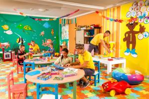 a group of children sitting at tables in a classroom at TUI MAGIC LIFE Penelope Beach - Families & Couples in Midoun