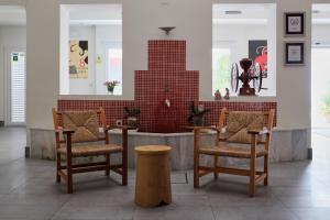 a restaurant with two chairs and a table and a counter at La Alcoba del Agua hotel boutique in Sanlúcar de Barrameda