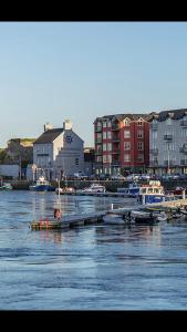 a group of boats are docked in a harbor at Greenway Holiday Home in Dungarvan