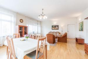 a dining room and living room with a table and chairs at Guesthouse Marija in Vilnius