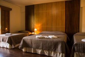 A bed or beds in a room at Hotel Matsubara