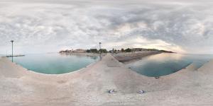 a large body of water with a beach in the background at Menios Apartments and Studios in Nea Kalikratia