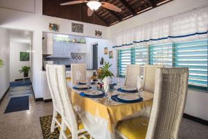 a dining room with a table and chairs at Beach Palms Villa in Silver Sands