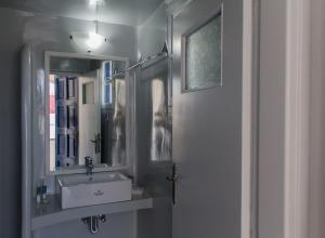 un bagno con lavandino e specchio di Edem a Firà