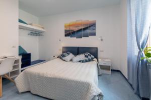 a white bedroom with a bed and a desk at Viaparsano in Sorrento +16 photos