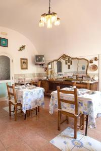 une salle à manger avec deux tables et un miroir dans l'établissement Hotel L'Argine Fiorito, à Atrani