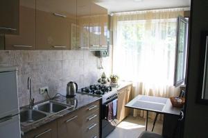 a kitchen with a sink and a stove at Hotel Liva in Mtskheta