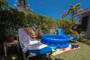 two chairs and a hot tub in a yard at Beach Palms Villa in Silver Sands