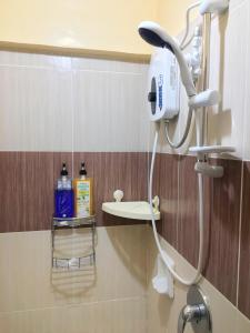 a bathroom with a blow dryer on the wall at Fully AC 3BR House for 8pax near Airport and SM with 100mbps Wifi in Puerto Princesa City