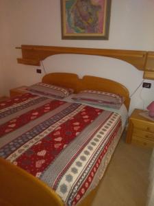 a bedroom with a bed with a quilt on it at Casa Iride in Canale San Bovo