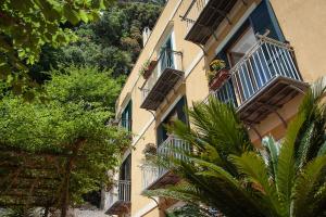 a building with balconies and plants on the side of it at Hotel L'Argine Fiorito in Atrani