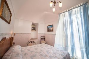 a bedroom with a bed and a large window at Hotel L'Argine Fiorito in Atrani