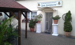 a entrance to a building with potted plants on it at Zum Holzwurm in Mühlanger