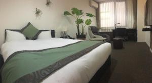 Postel nebo postele na pokoji v ubytování Hotel Tohkai