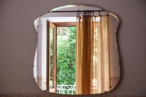 a mirror reflection of a window in a room at Hotel L'Argine Fiorito in Atrani