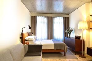 A bed or beds in a room at My Story Apartments Porto - Santa Catarina