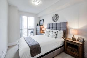 a bedroom with a large bed and a window at CHOL Suites - 2 Beds CN Tower, Downtown Toronto-Metro Toronto Convention Centre-300 Front Street W in Toronto