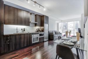 a kitchen and dining room with a table and a dining room at CHOL Suites - 2 Beds CN Tower, Downtown Toronto-Metro Toronto Convention Centre-300 Front Street W in Toronto