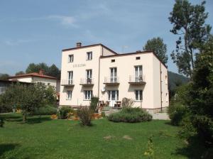 a large white building with a yard in front of it at WILLA "SZCZĘSNA" in Piwniczna
